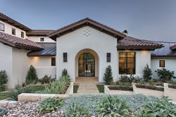 Residential entry featuring stone detailing, natural materials, and contemporary Mediterranean desig
