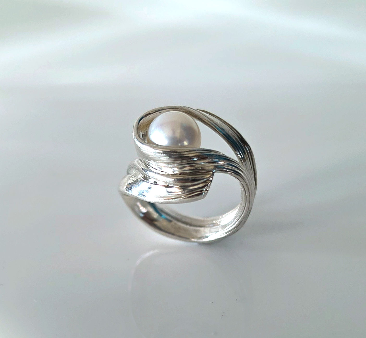 silver sculpted ring with a pearl
