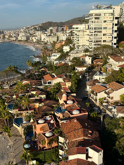 Scenic aerial view of buildings near a beach and ocean Ayalaproperties