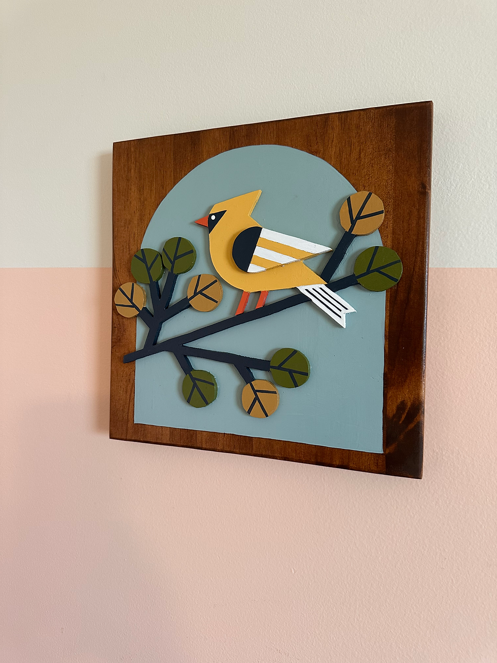 Thumbnail: Layered yellow bird art on branch, wooden frame, blue arch background.
