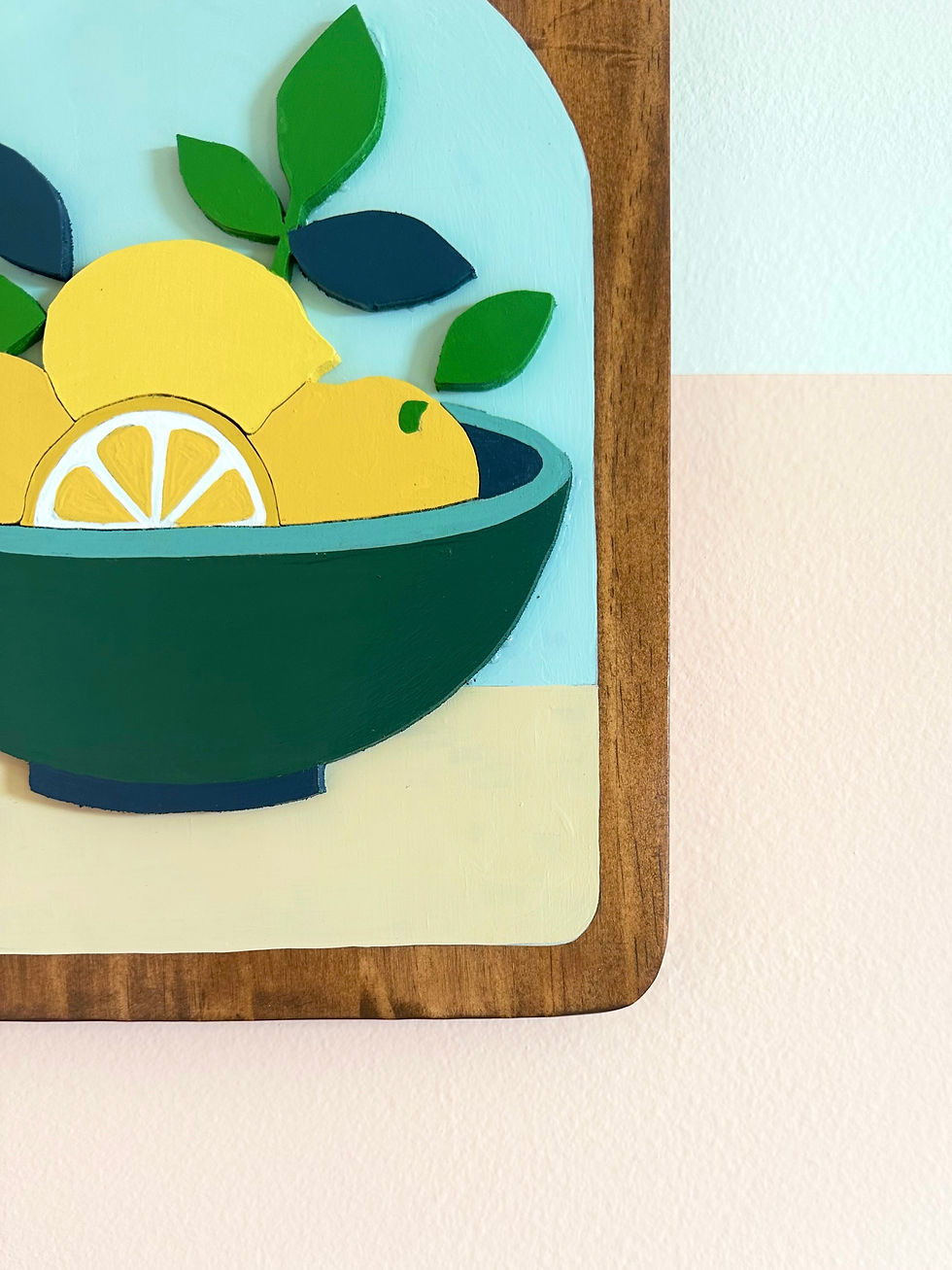 Thumbnail: Wooden board featuring a colorful bowl of yellow lemons and green leaves.