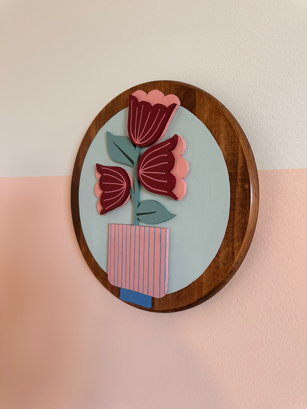 Thumbnail: Wooden plaque with stylized pink and maroon flowers in striped vase artwork.