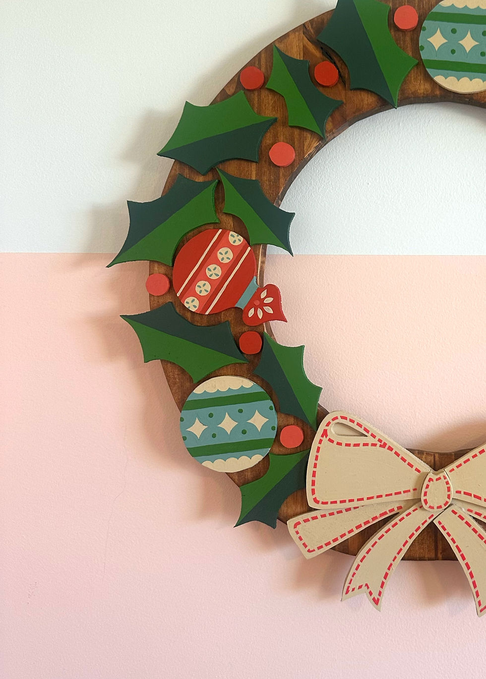 Thumbnail: Wooden Christmas wreath featuring holly, festive ornaments, and a large bow.