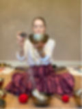 women healing with golden bowl on mat