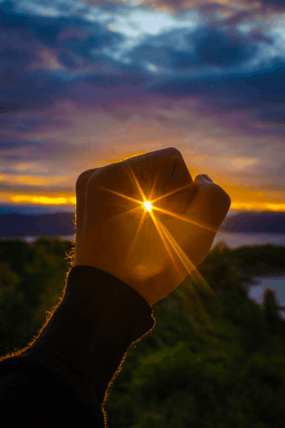 Hand holding a sun ray gif