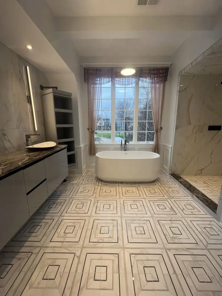 Bathroom with freestanding tub and geometric marble-look floor, Bay Village