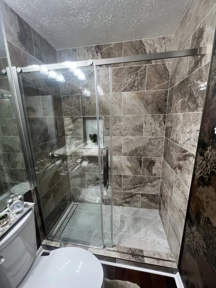 Walk-in shower with brown marble-look porcelain, sliding glass door, linear drain and niche, Ravenna, Ohio