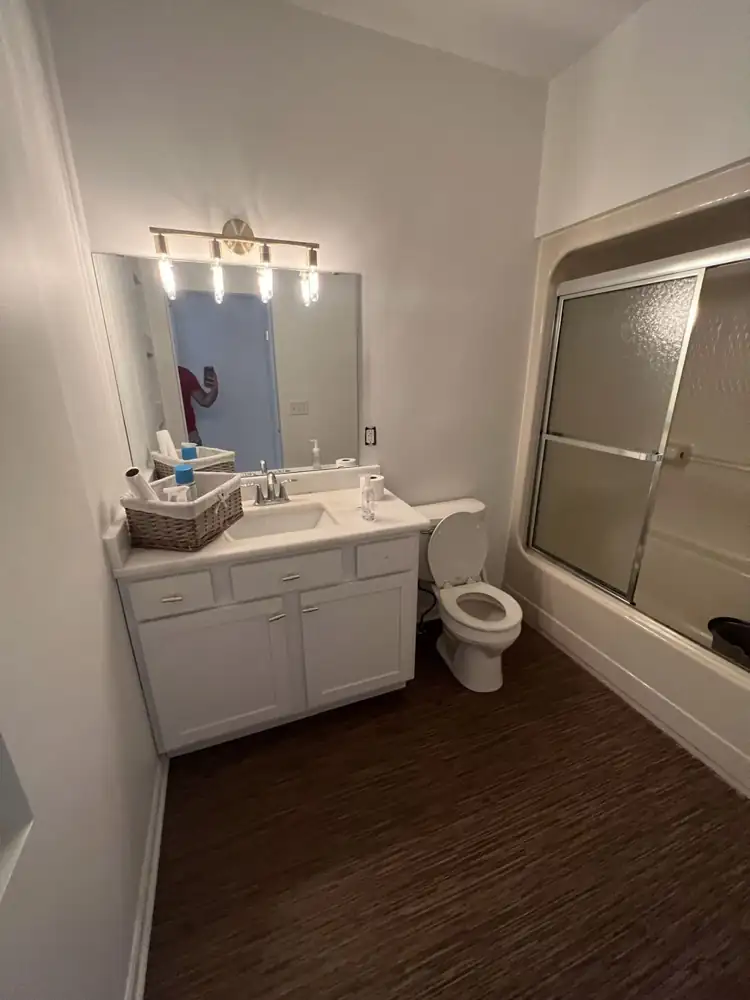 Bathroom before remodel with tub and sliding doors, Amherst