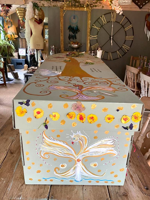 coffin decorated with a gold tree