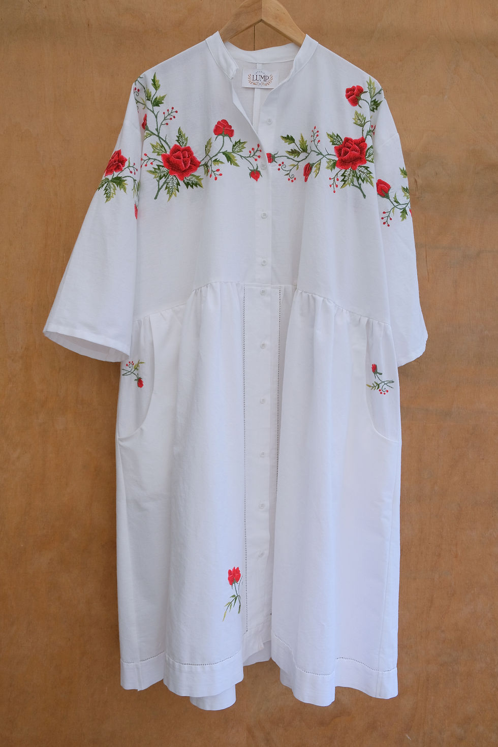 White dress with red flower embroidery