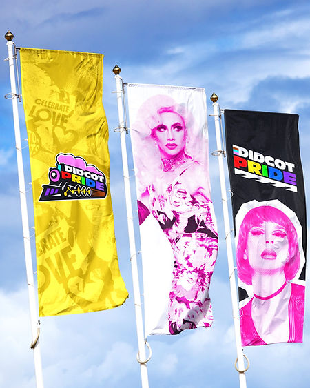 A collection of paper cups are placed on a surface with Didcot Pride branding printed on the cup. 