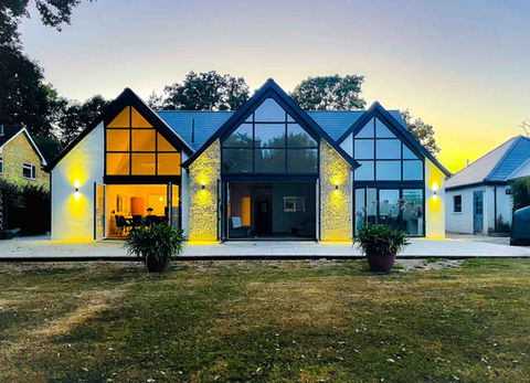 Sunset of Rear view of modern and high-end bungalow conversion. 