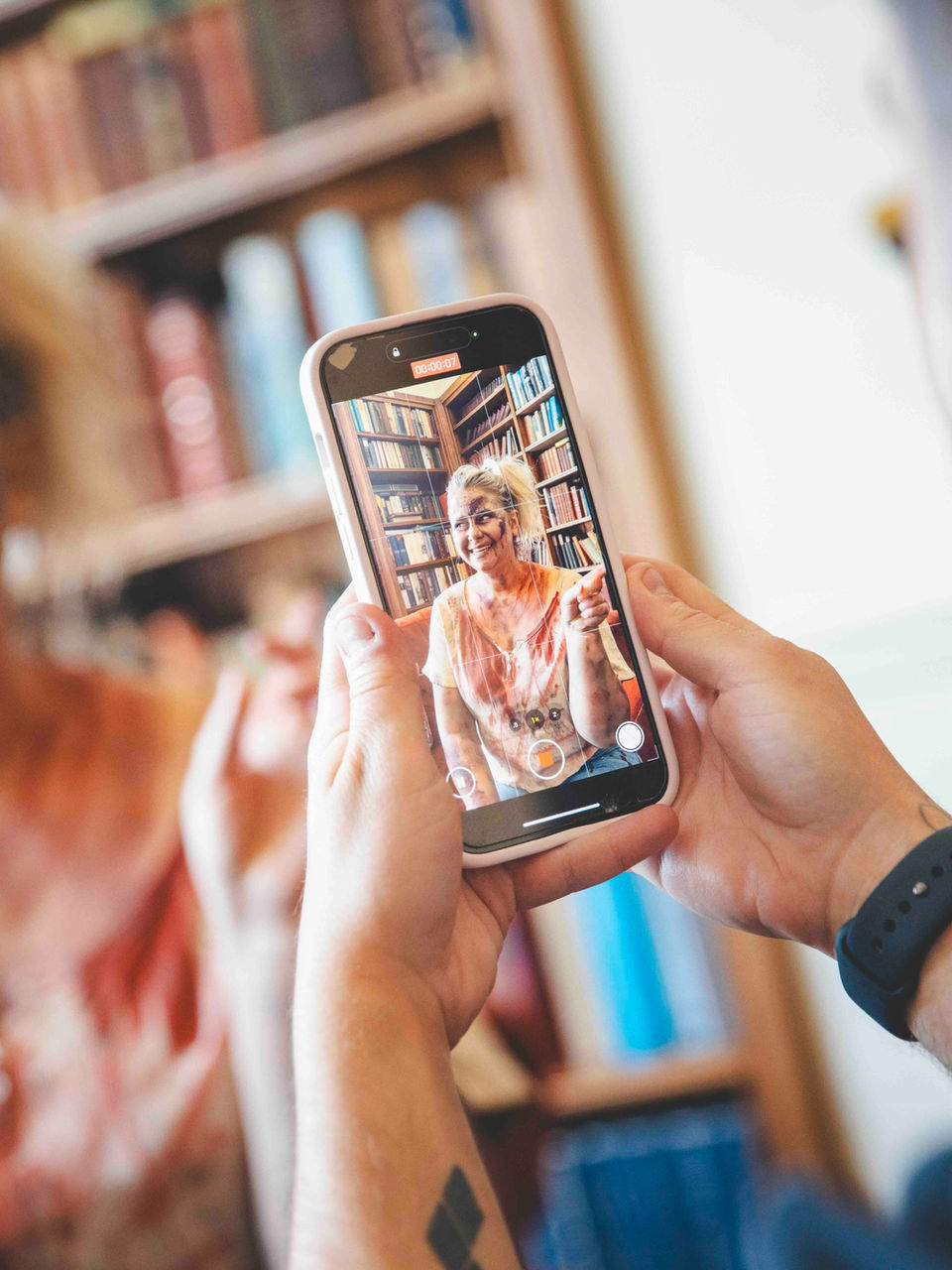 Marketer creating social media video content on set of a promotional advert.