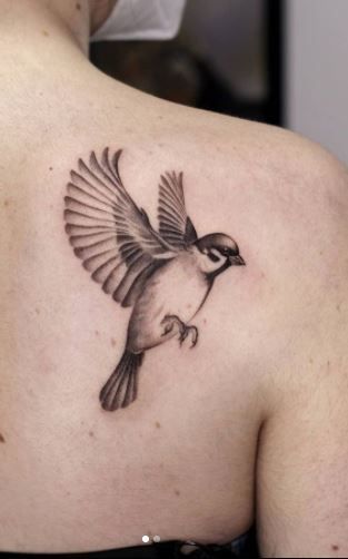  Colorful bird tattoo design on a branch