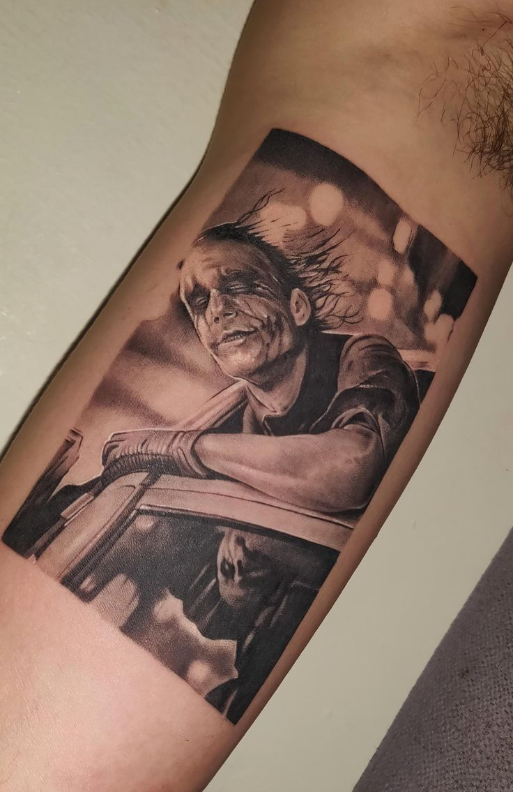Joker tattoo with knife weapon design