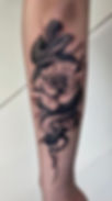 American traditional snake tattoo with bold black outlines and red scales — classic old school rattlesnake flash design