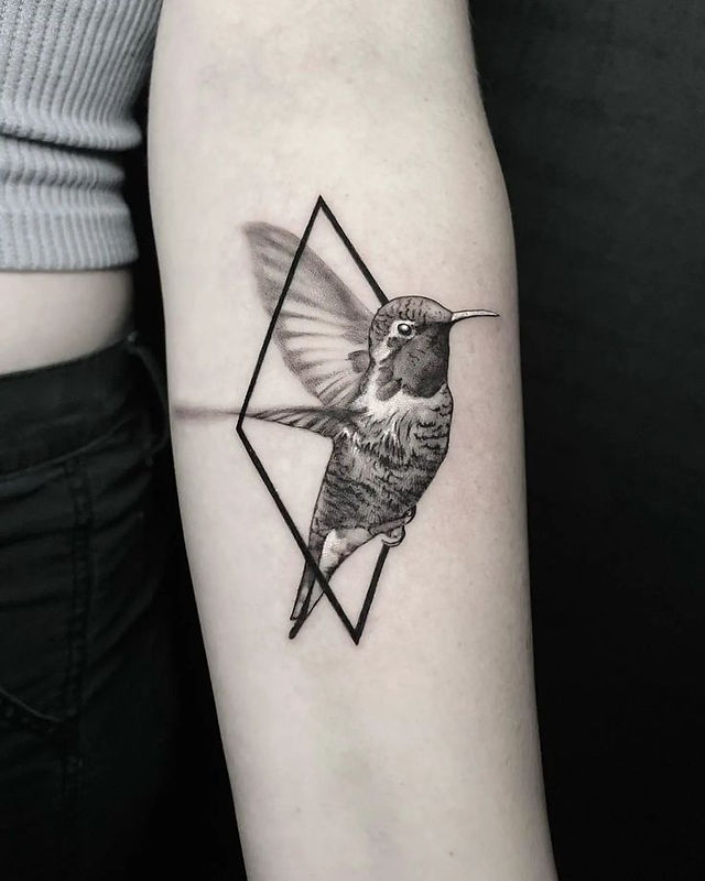  Colorful bird tattoo design on a branch