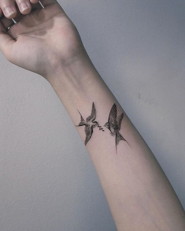  Colorful bird tattoo design on a branch