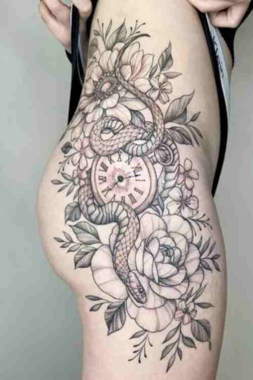 timeless female snake tattoo covering the leg