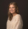Smiling woman headshot, wearing cream sweater