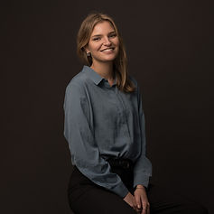 Smiling woman in blue shirt, professional headshot