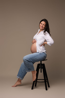 Pregnant woman posing on a chair