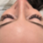 Close-up of full volume eyelash extensions on closed eyes