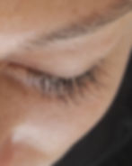 Close-up of a closed eye with natural eyelashes and eyebrow