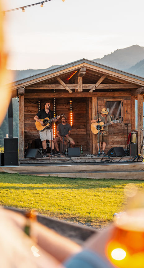 Musicians play on the mountain at sunset