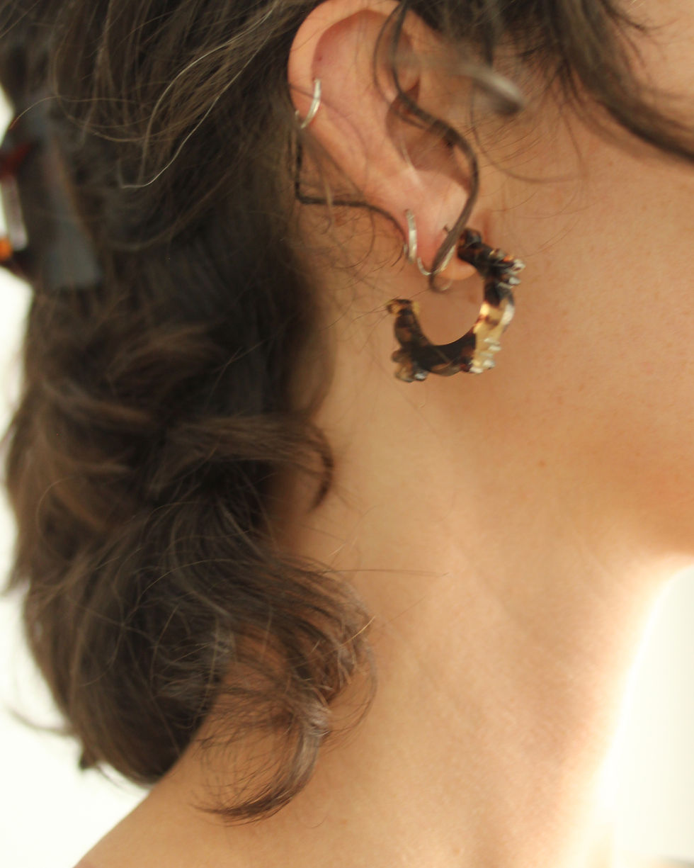 Thumbnail: small hoops with patterned edging in tortoiseshell, shown in ear