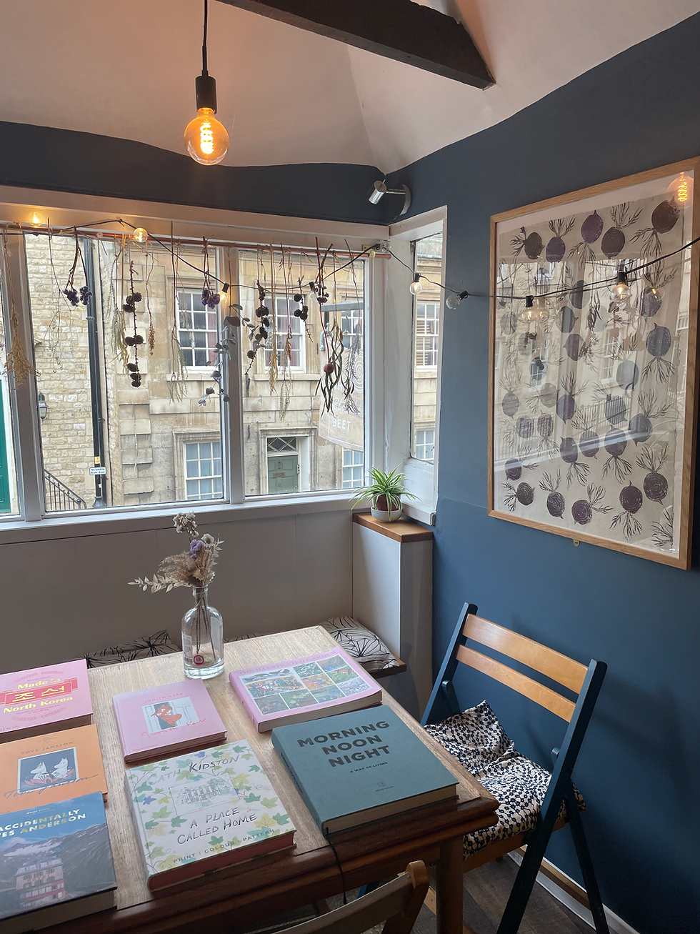 Close-up view of a print featuring whimsical wildflowers displayed in the café