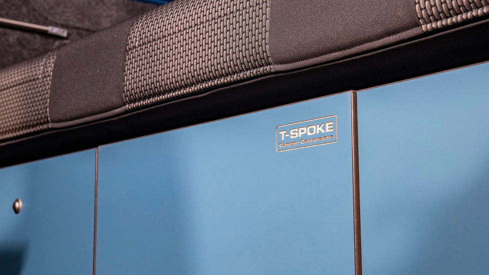 RIB bed in campervan conversion with blue front face units
