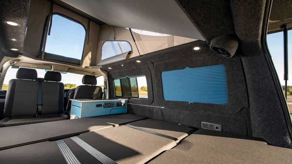Elevating roof with zip out window blue campervan conversion full width bed kitchen pod blinds double passenger swivel seat