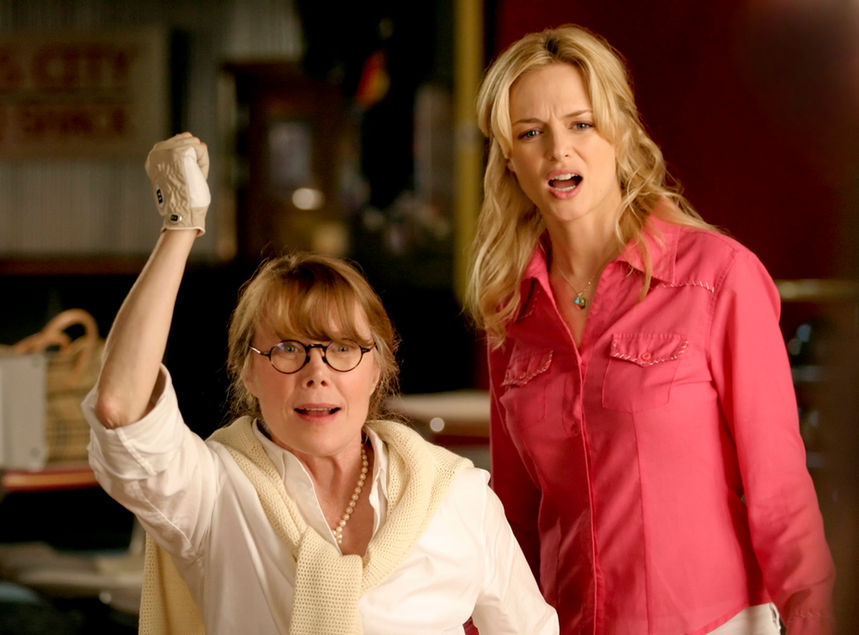 Unit Stills portfolio image of two women, 50's and 20's in what appears to be in a bowling lane.  The woman in her 50's just finished throwing her ball as the other woman looks on surprised at her skills.