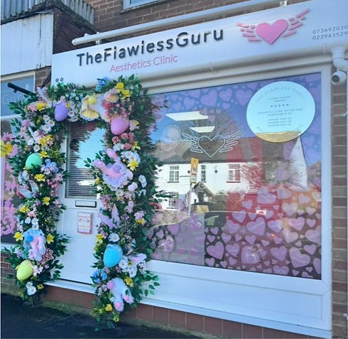 The Flawless Guru Aesthetics Clinic storefront with floral decor
