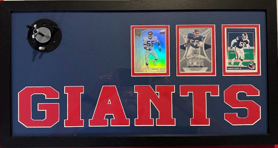 Thumbnail: Close-up of sports cards in Lawrence Taylor New York Giants framed memorabilia display