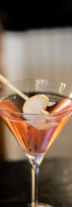 A beautifully crafted cocktail featuring a garnish, highlighting its enticing colors and inviting appearance.