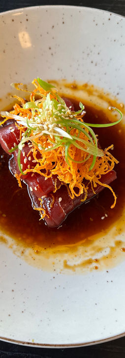 A round plate displaying a carefully prepared meal, highlighting its textures and colors.