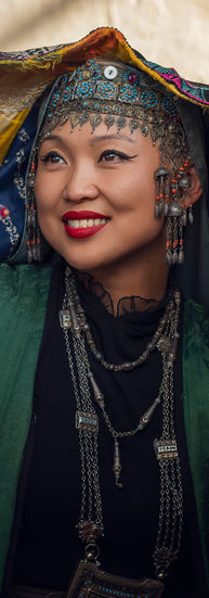 Fashion portrait of a woman in traditional ethnic headdress and green robe, studio photography in Houston TX.