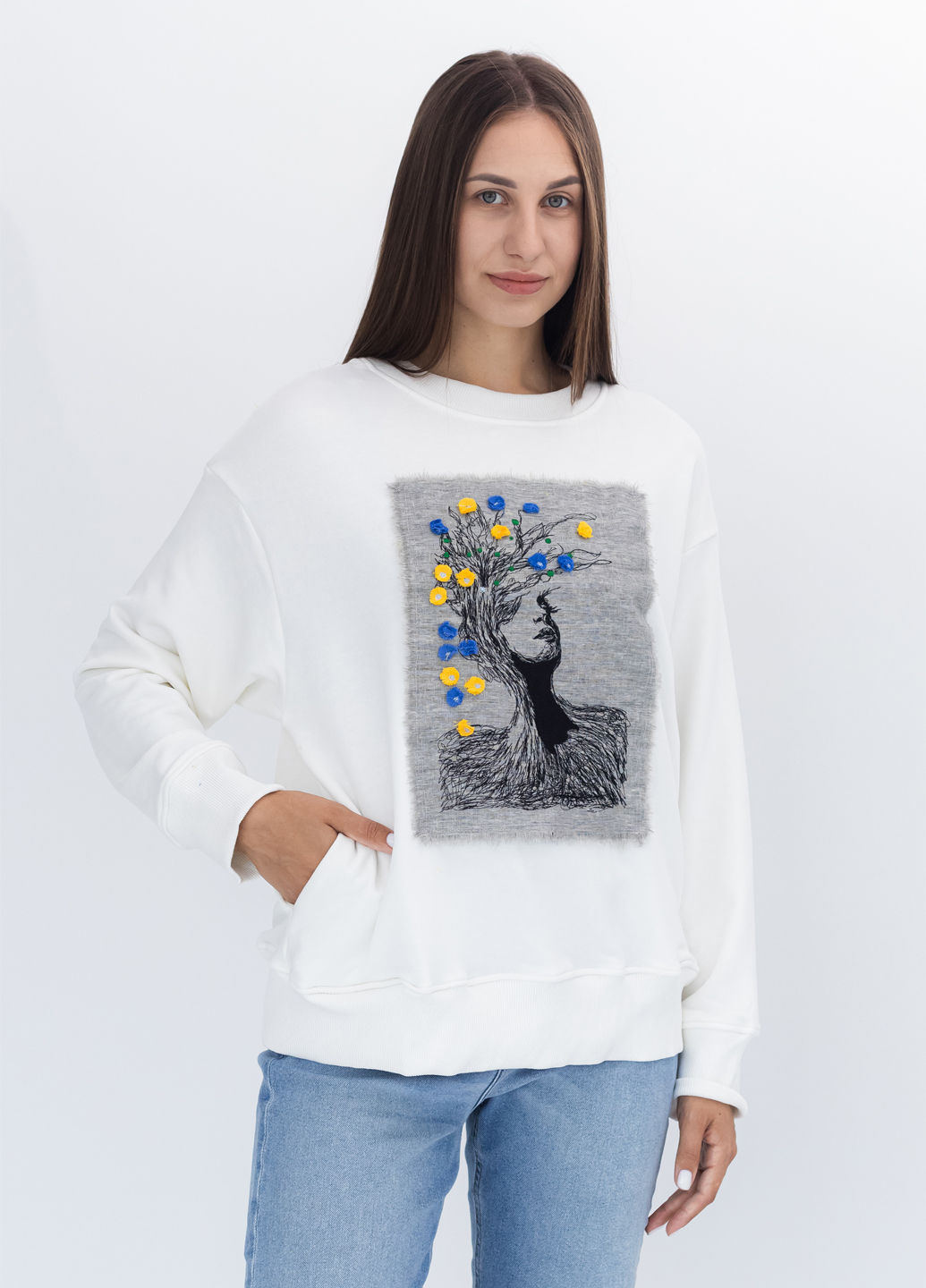 Female model wearing a designer sweatshirt with a vibrant graphic.