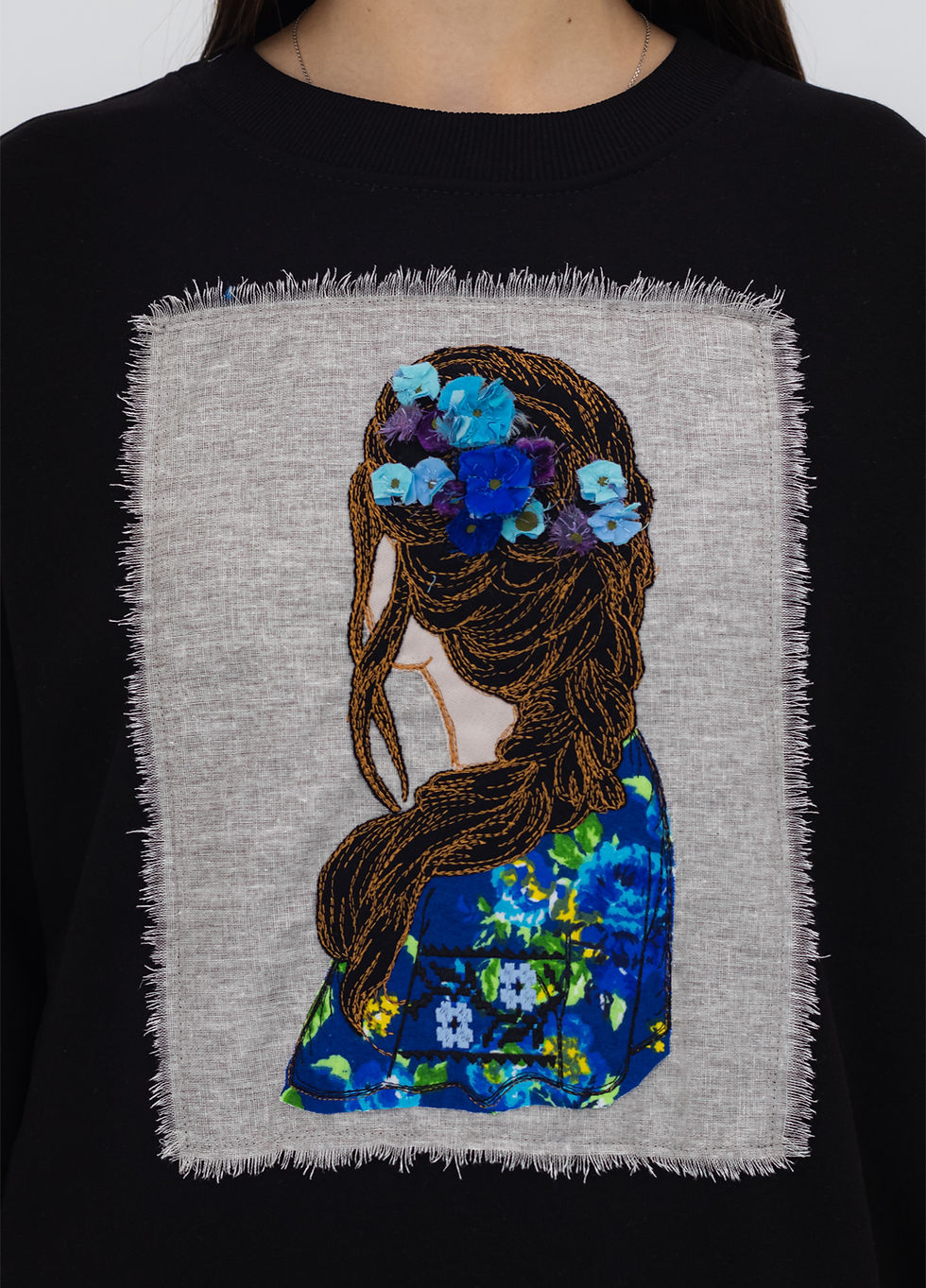 Thumbnail: Female model wearing a designer sweatshirt with a vibrant graphic