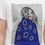 Thumbnail: Female model wearing a designer t-shirt with a vibrant graphic