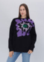 Female model wearing a designer sweatshirt with a vibrant graphic.