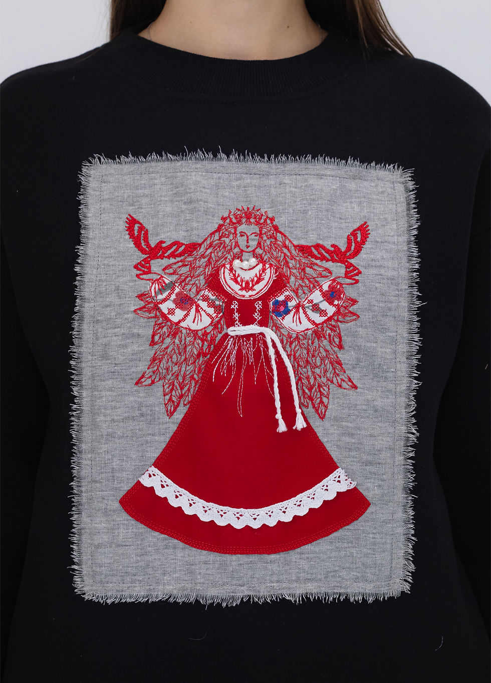 Thumbnail: Female model wearing a designer sweatshirt with a vibrant graphic
