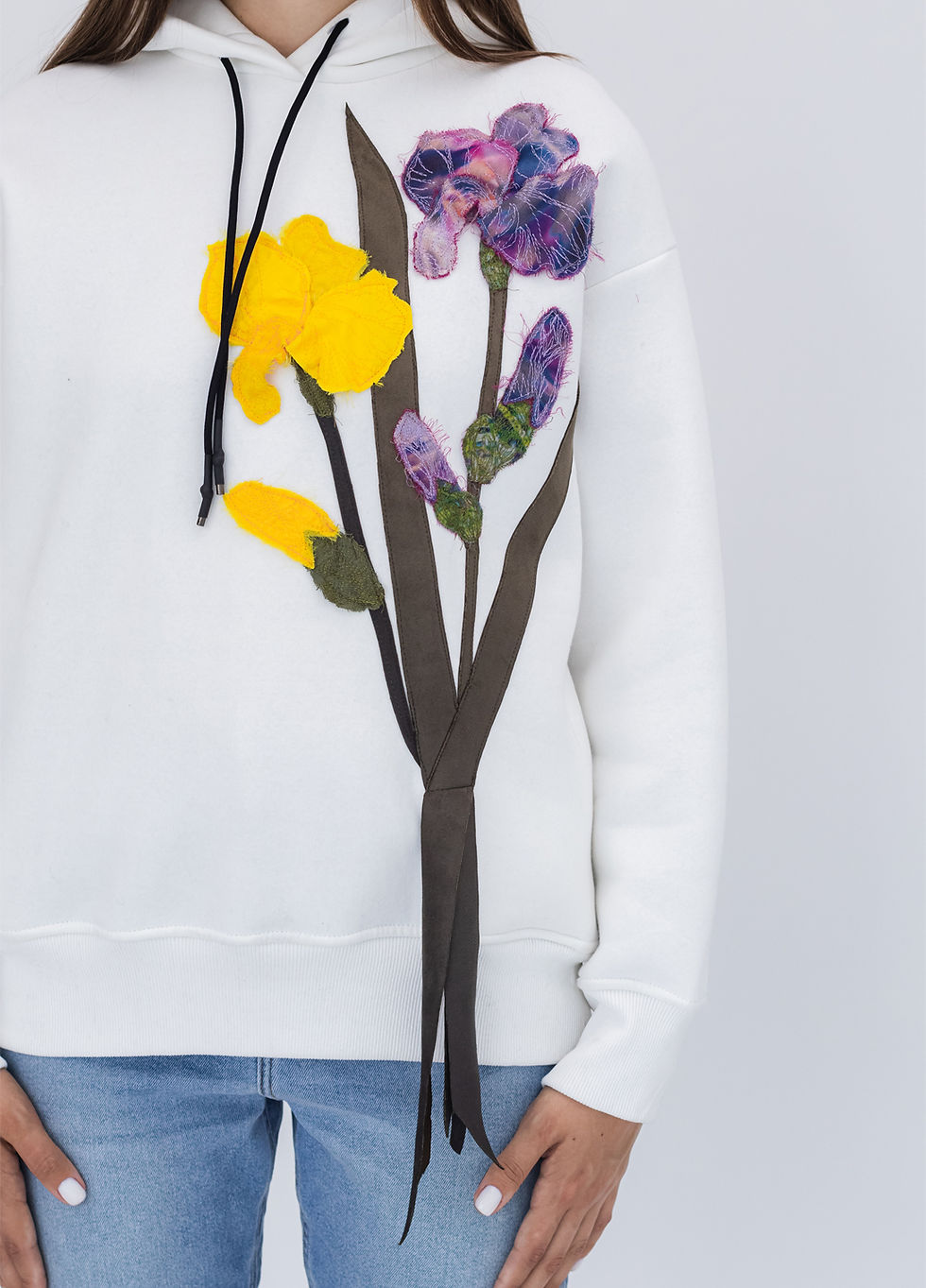 Thumbnail: Female model wearing a designer hoodie with a vibrant graphic