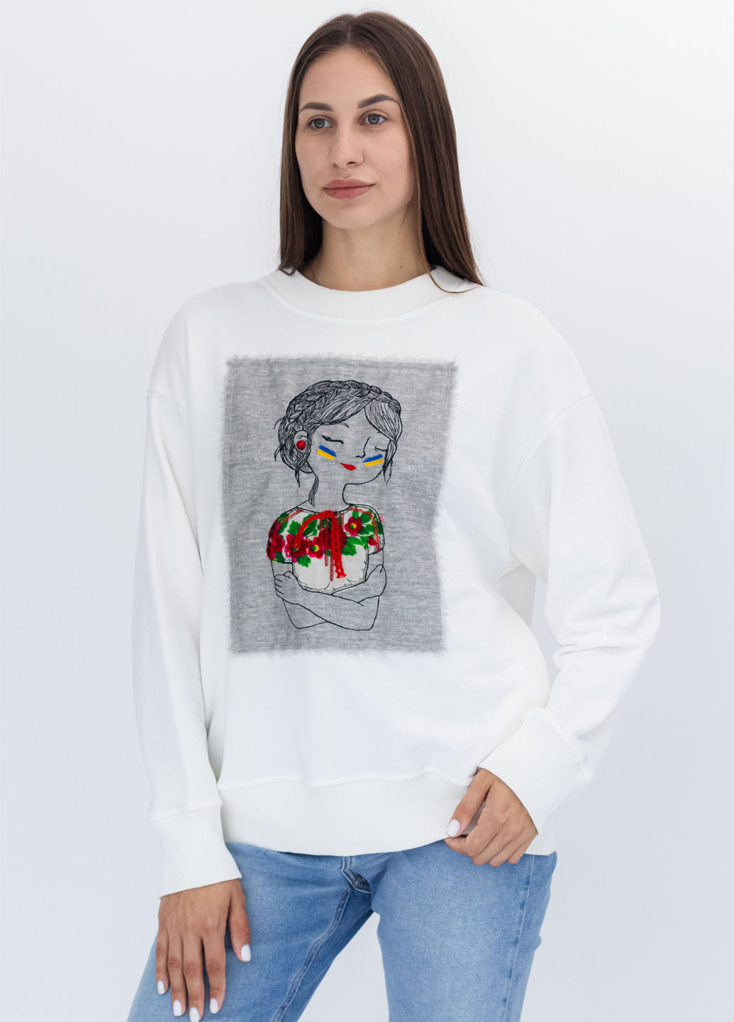 Female model wearing a designer sweatshirt with a vibrant graphic