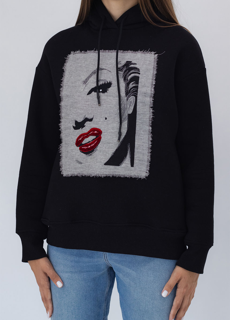 Прев'ю: Female model wearing a designer hoodie with a vibrant graphic