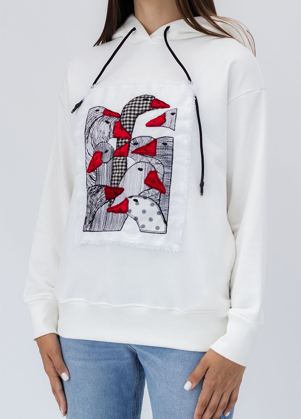 Thumbnail: Female model wearing a designer hoodie with a vibrant graphic