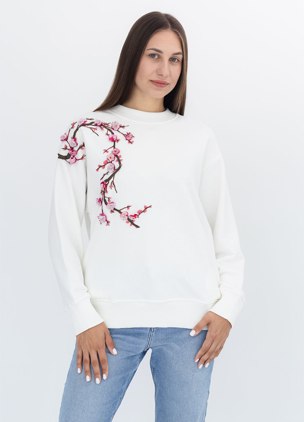 Female model wearing a designer sweatshirt with a vibrant graphic