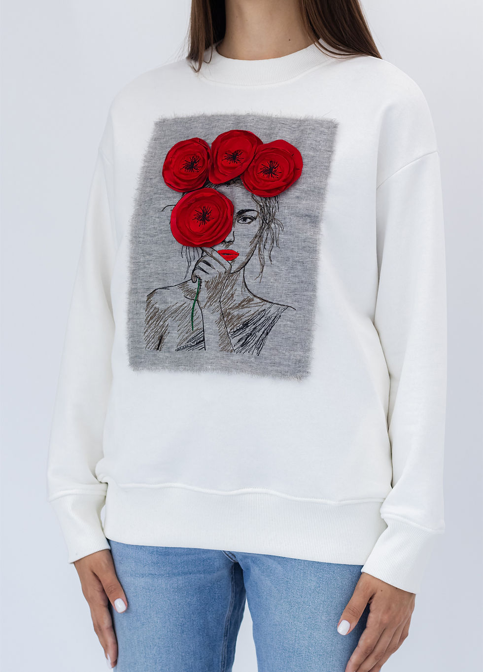 Прев'ю: Female model wearing a designer sweatshirt with a vibrant graphic